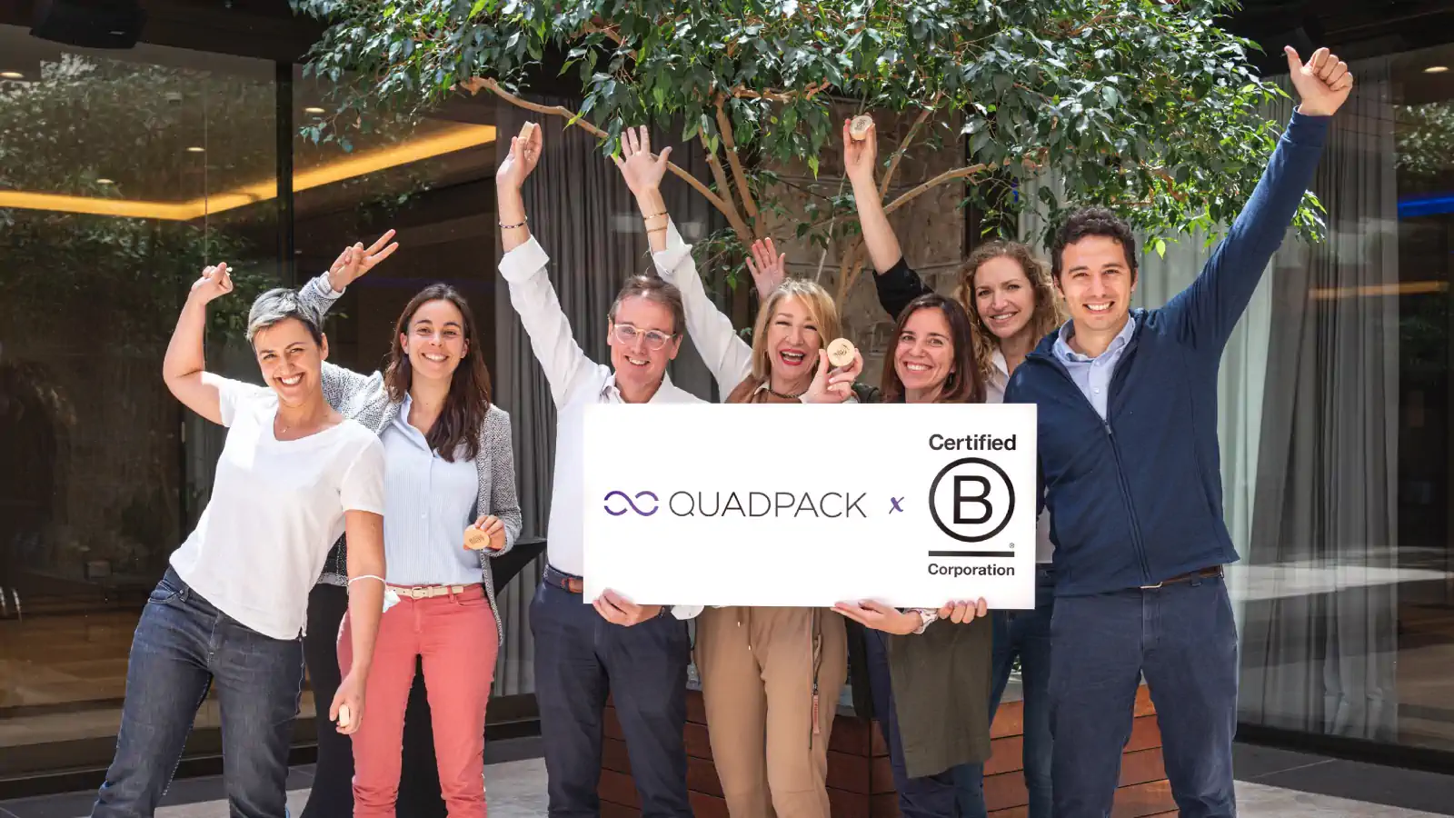 Tim Eaves and some of his employees, holding the B Corp certification.